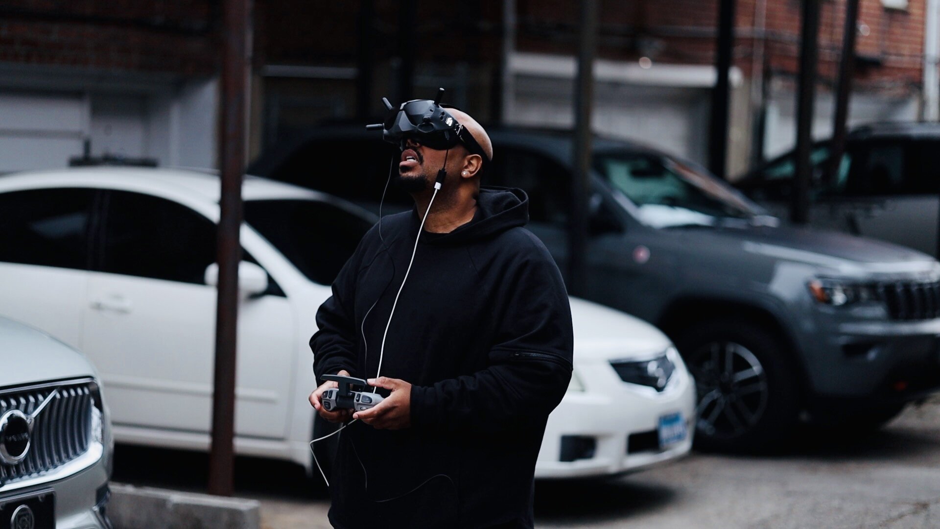Brandon operating drone with FPV goggles on film set