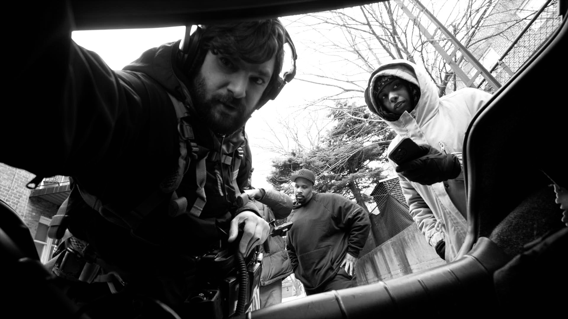 Film crew setting up a shot inside a car on location